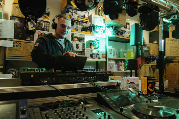 Man met koptelefoon bedient een dj-set